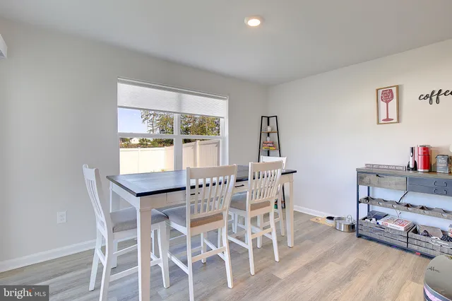 a open kitchen with stainless steel appliances granite countertop a sink dishwasher stove refrigerator and cabinets with wooden floor