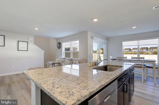 a open kitchen with stainless steel appliances granite countertop a lot of counter space and wooden floor