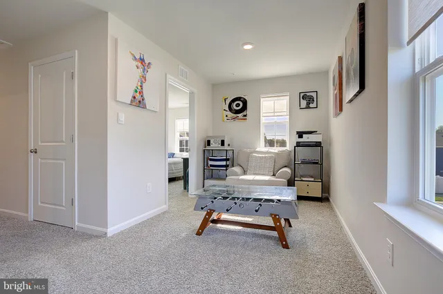 a view of livingroom with furniture and workspace