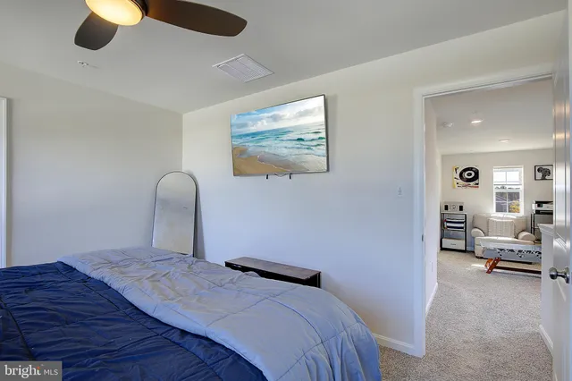 a bed sitting in a bedroom next to a lamp