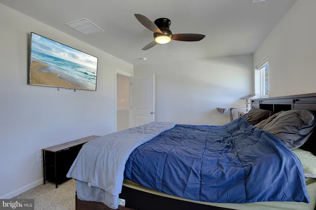 a bathroom with a granite countertop sink a mirror and shower