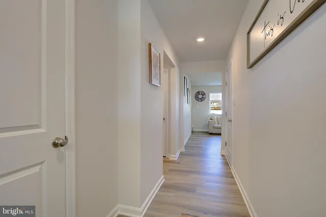 a hallway with table and closet