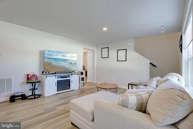 a kitchen with stainless steel appliances granite countertop a table chairs refrigerator and sink