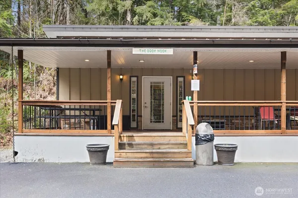a view of a house with a patio and a yard
