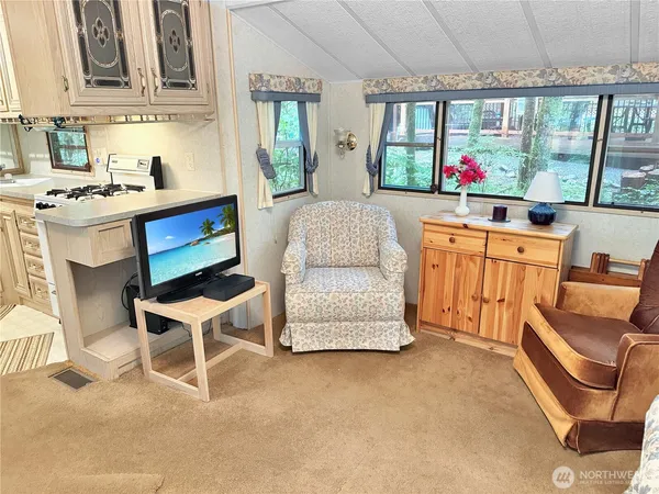 a bedroom with furniture and a large window