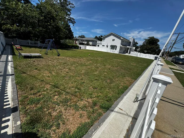 a view of a yard with potted plants