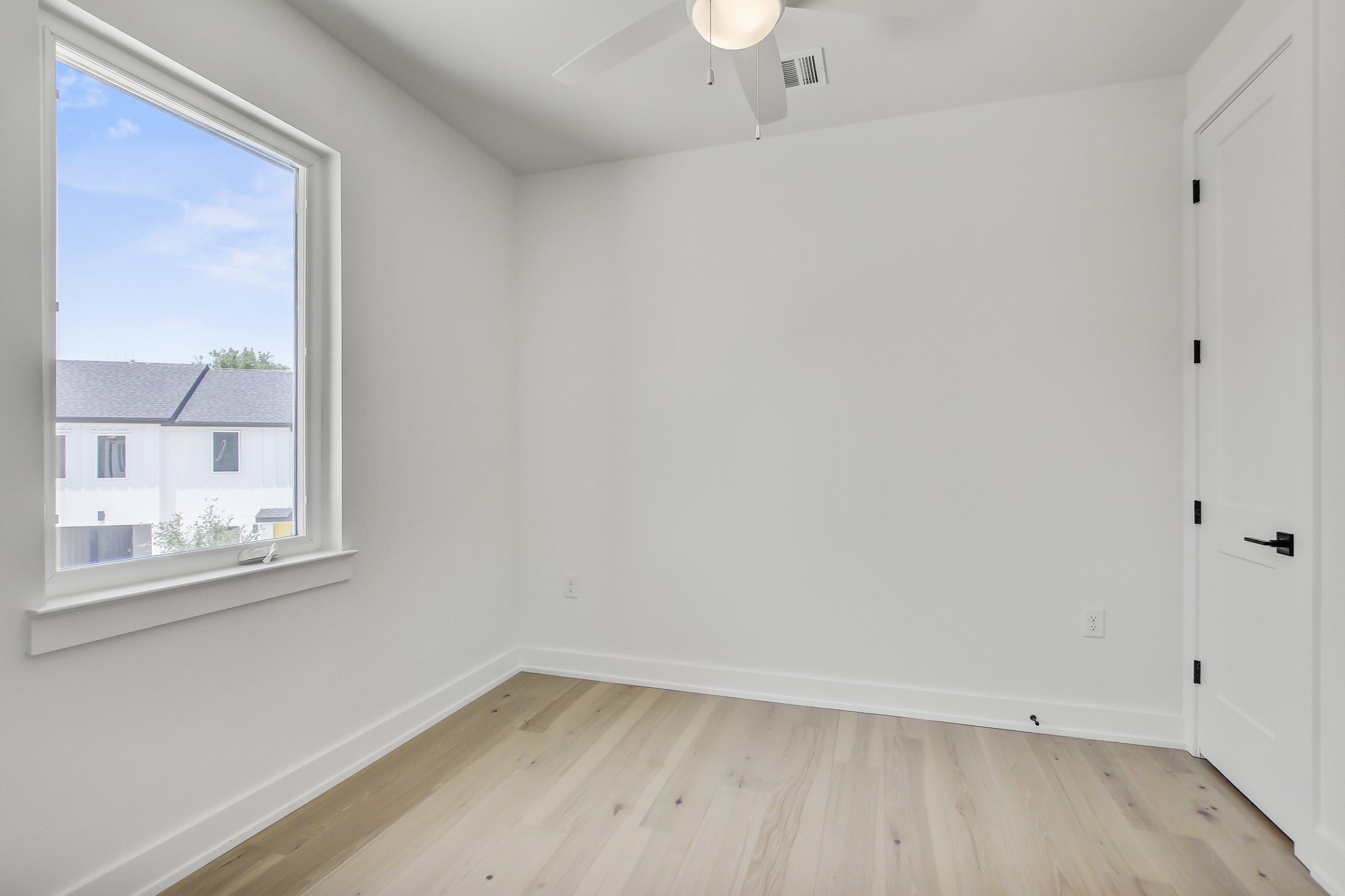 4127 East 12th Street, Unit 8 Austin, TX 78721 - Photo 26 of 32 Spare room featuring light wood-style floors, ceiling fan, and baseboards