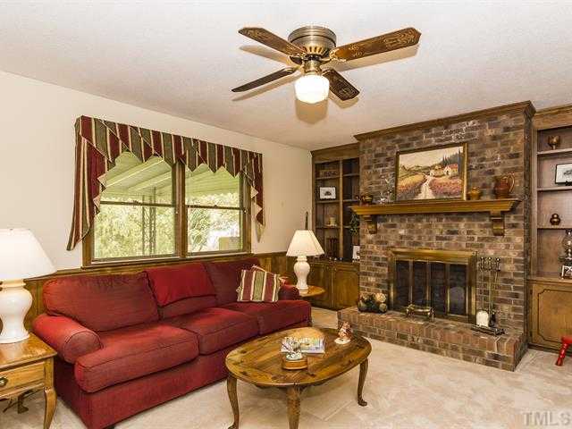 3508 Campbell Road Raleigh, NC 27606 - Photo 13 of 23 masonary fireplace with gas logs and built ins flanking fireplace