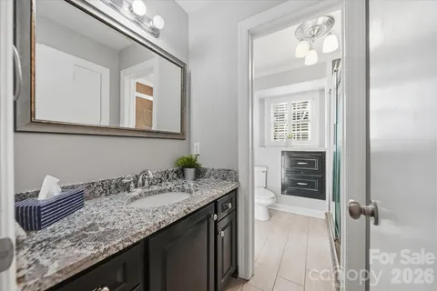 a view of empty room with wooden floor and windows