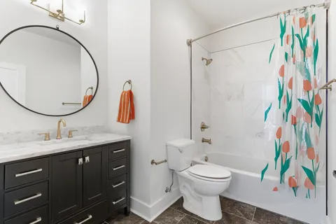 a bathroom with a toilet a sink and a mirror
