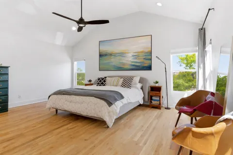a bedroom with a bed a couch and a window