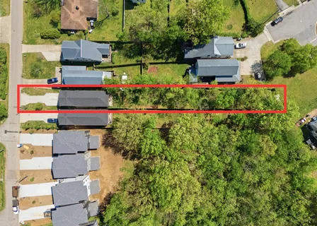an aerial view of a house with a yard and garden