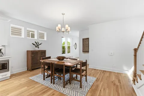 a view of a dining room with furniture wooden floor and chandelier