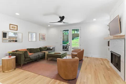 a living room with furniture a window and a fireplace