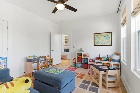 a living room with furniture and a baby crib
