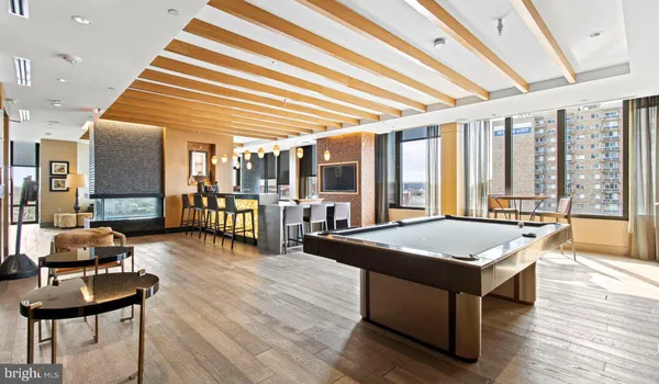a room with pool table and glass windows