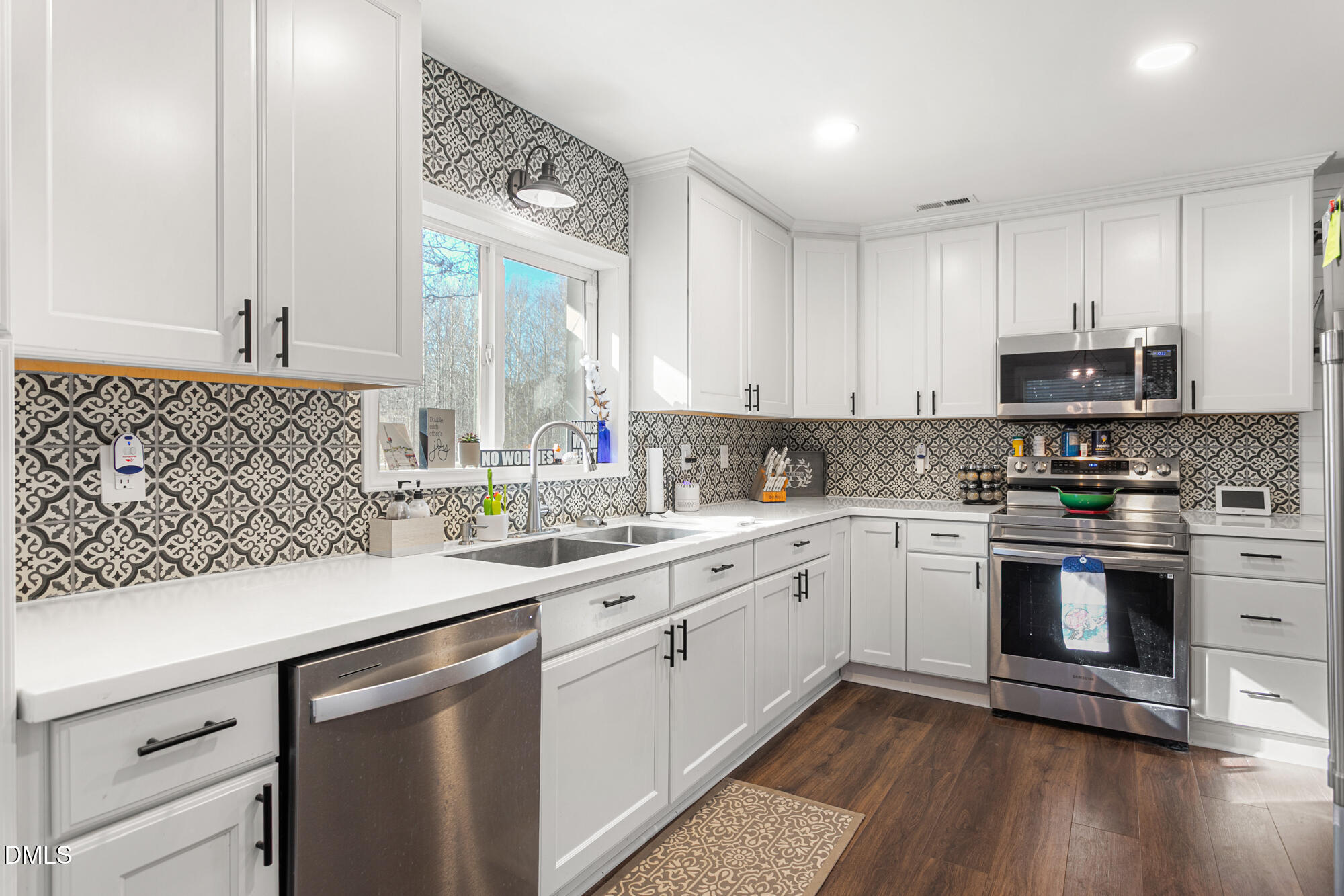 4244 Alamance Church Road Liberty, NC 27298 - Photo 6 of 37 a kitchen with stainless steel appliances white cabinets a sink and a stove