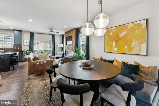 a living room with dining table and a large window