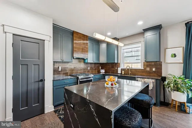 a kitchen with a table chairs sink and cabinets