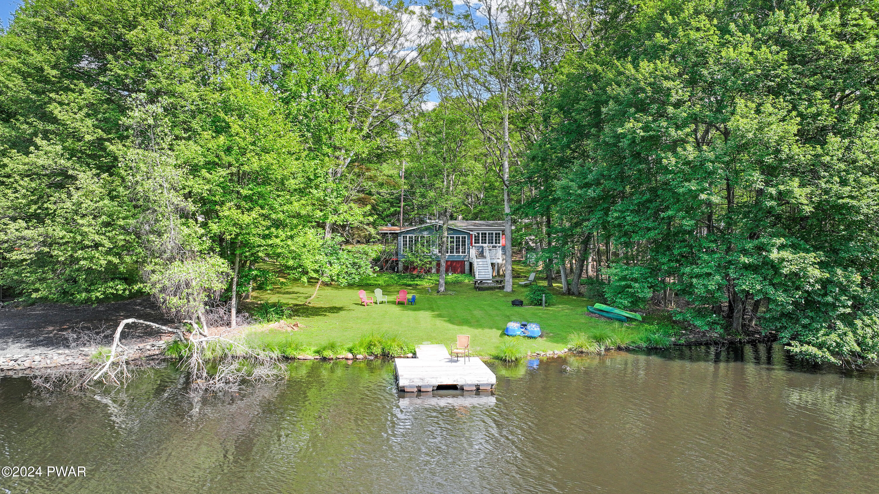 130 Beech Road Dingmans Ferry, PA 18328 - Photo 1 of 31 a view of a lake with a house in the background