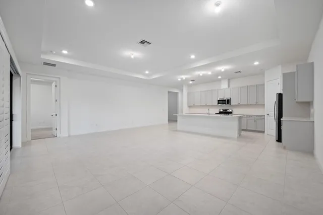 a view of kitchen with center island and stainless steel appliances