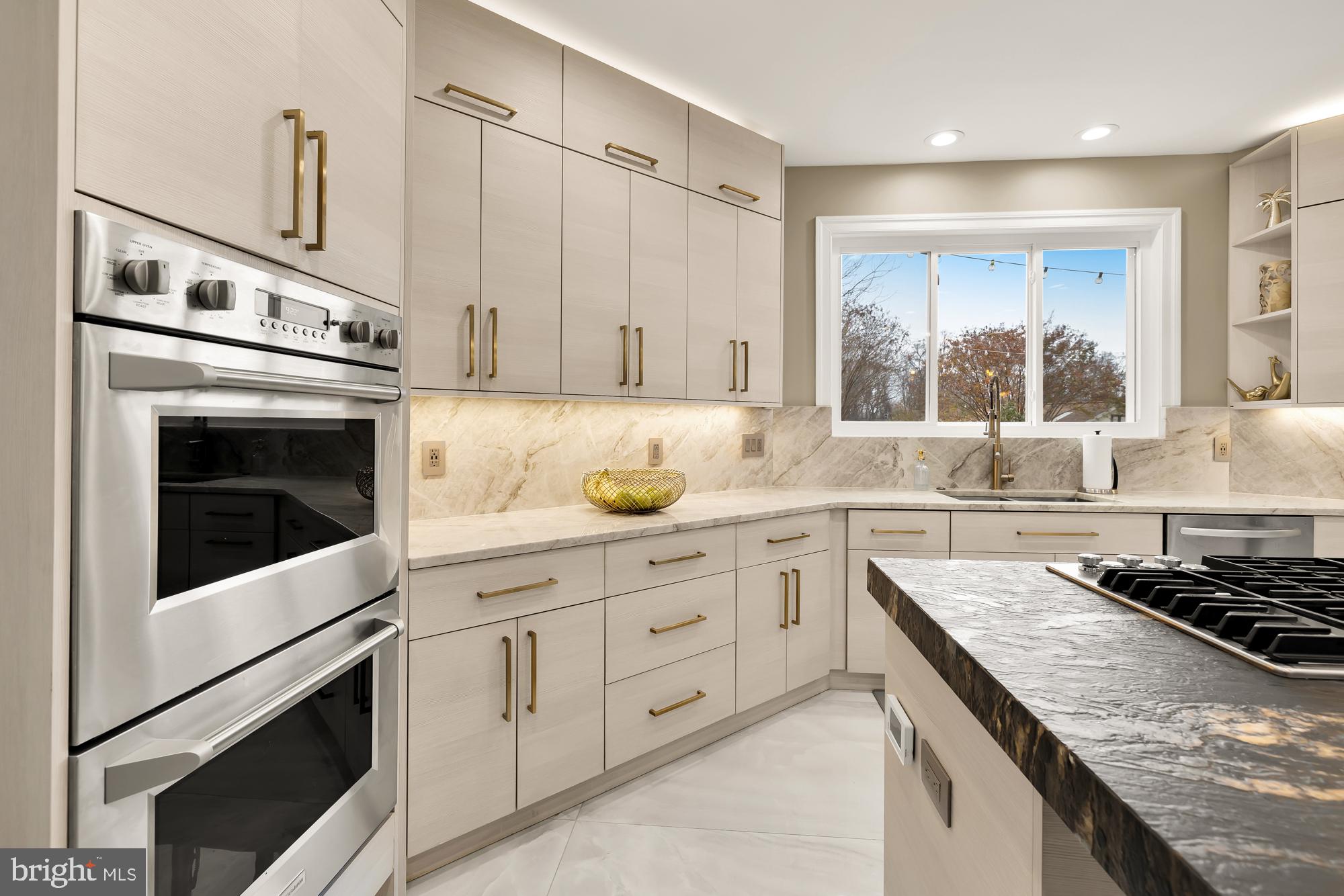 19109 Peale Lane Leesburg, VA 20175 - Photo 25 of 135 a kitchen with granite countertop a stove sink and cabinets