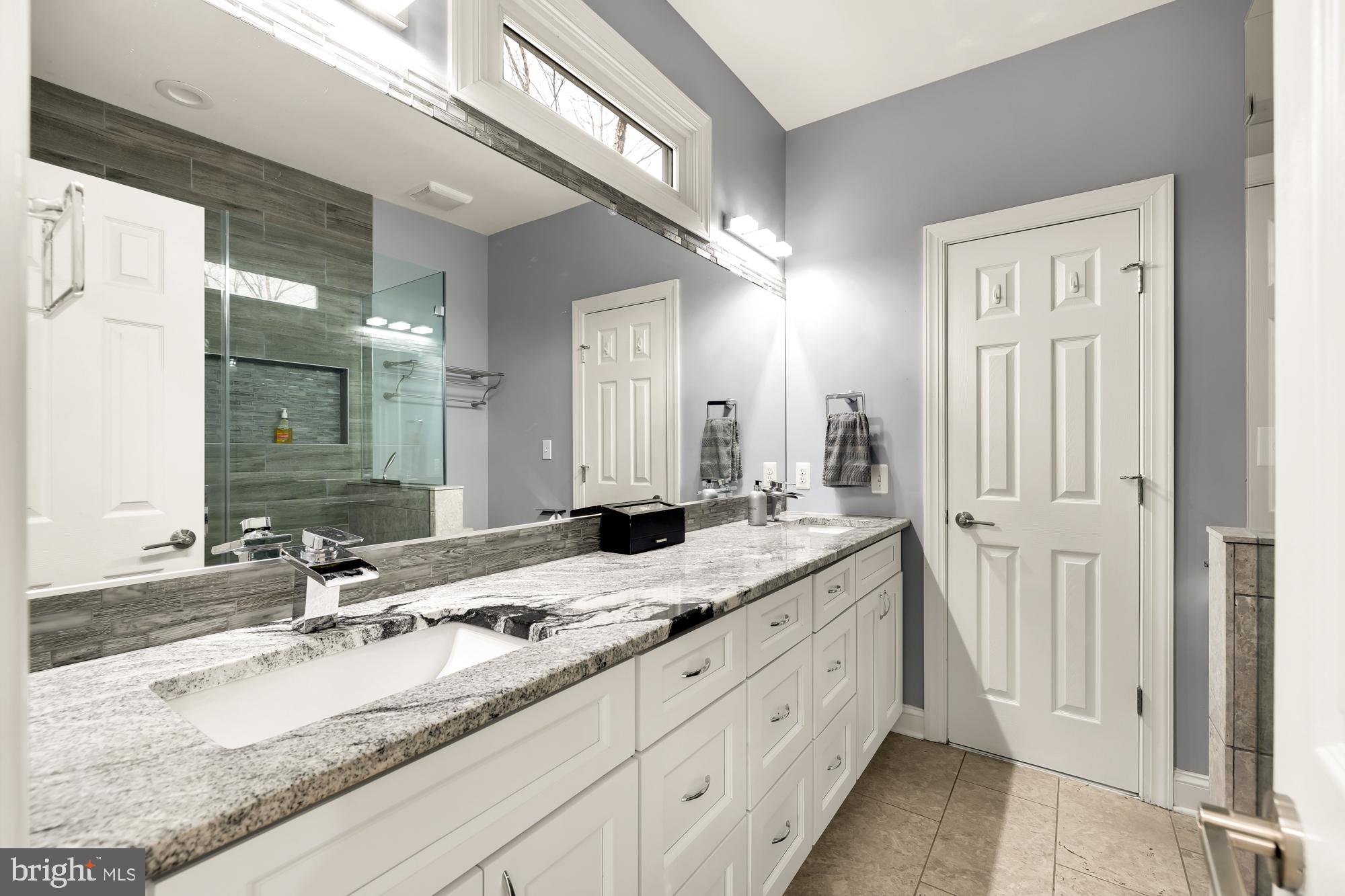19109 Peale Lane Leesburg, VA 20175 - Photo 62 of 135 a bathroom with a granite countertop double vanity sink and a mirror