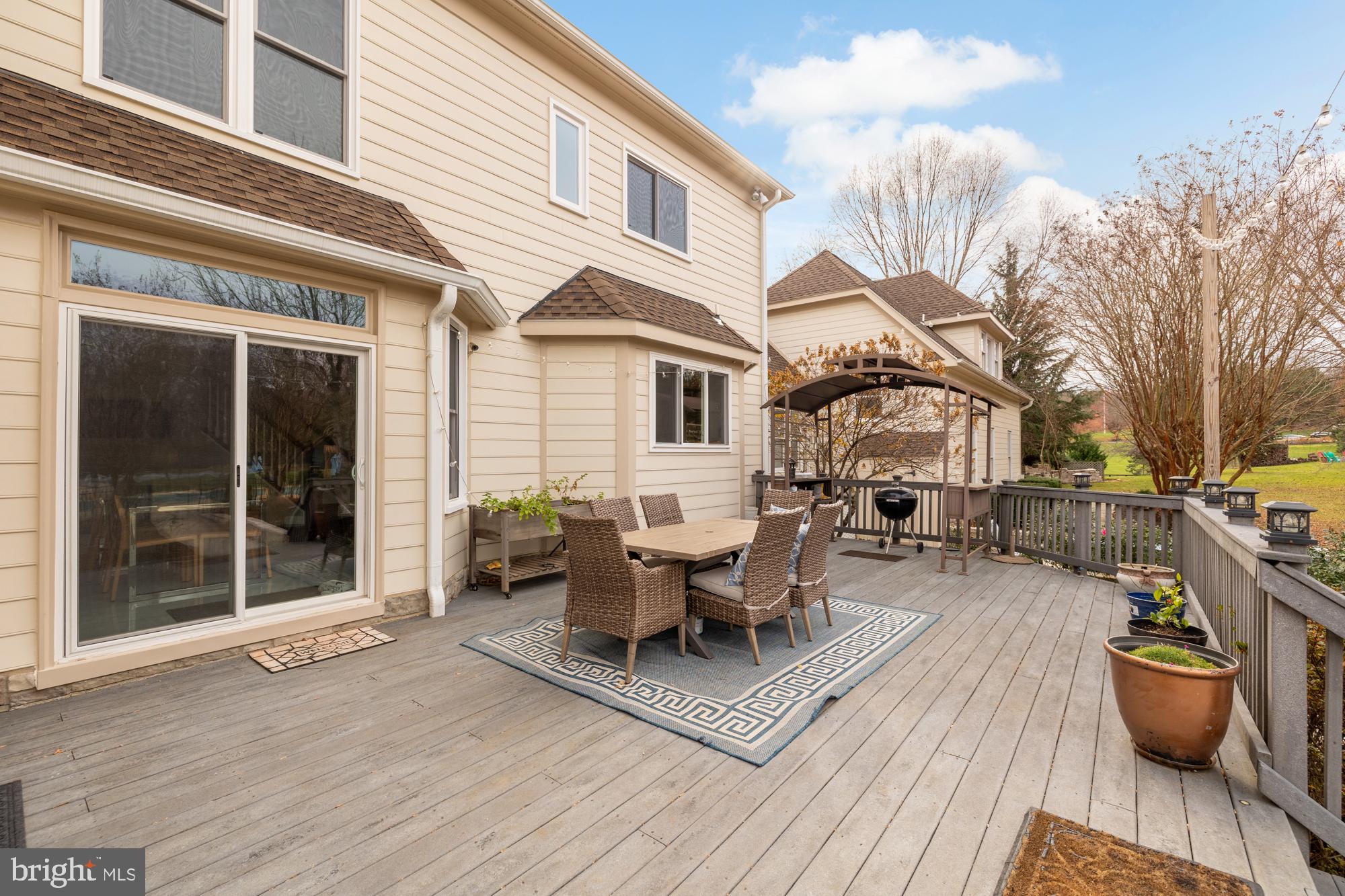 19109 Peale Lane Leesburg, VA 20175 - Photo 98 of 135 a view of a patio with couches table and chairs and potted plants
