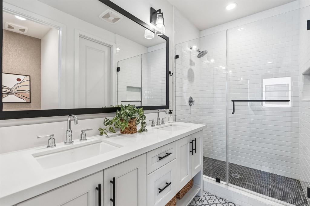 1602 San Remo Place, Unit 201 Encinitas, CA 92024 - Photo 25 of 56 a bathroom with a sink and a mirror