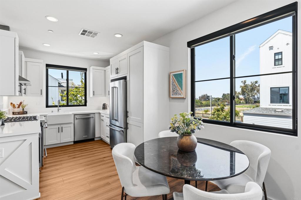 1602 San Remo Place, Unit 201 Encinitas, CA 92024 - Photo 3 of 56 a kitchen with a table and chairs