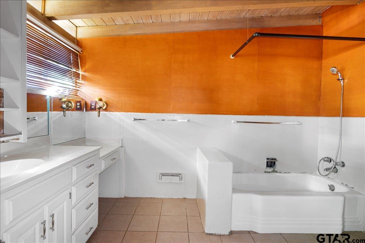 904 East Dulse Street Tyler, TX 75701 - Photo 14 of 27 a bathroom with a double vanity sink and a mirror