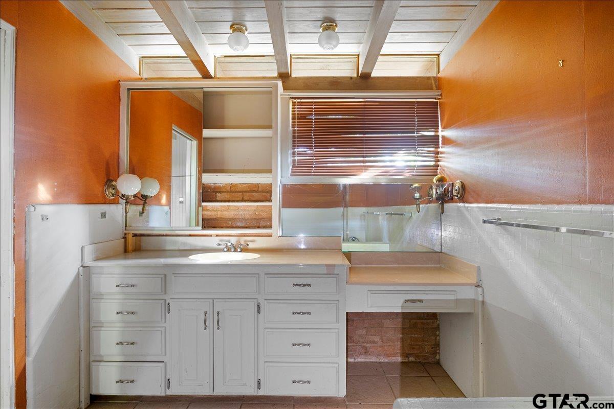 904 East Dulse Street Tyler, TX 75701 - Photo 15 of 27 a bathroom with a sink and a mirror