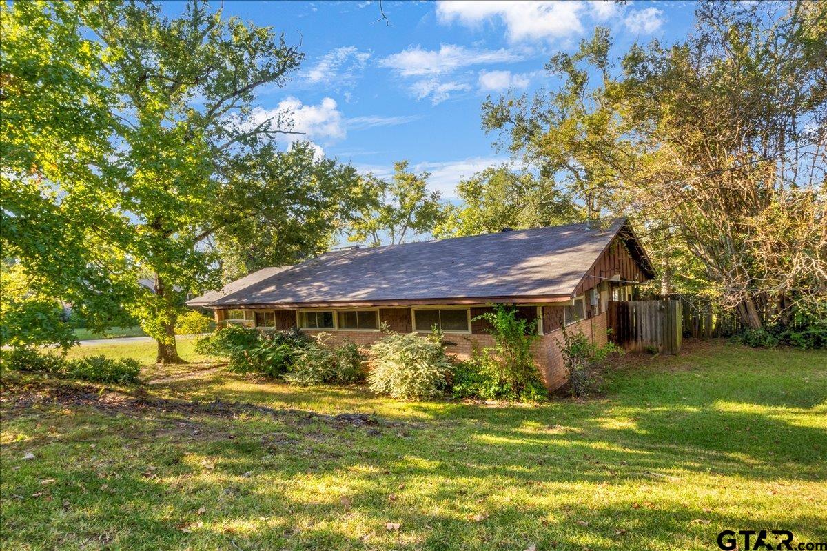 904 East Dulse Street Tyler, TX 75701 - Photo 2 of 27 a front view of a house with a garden