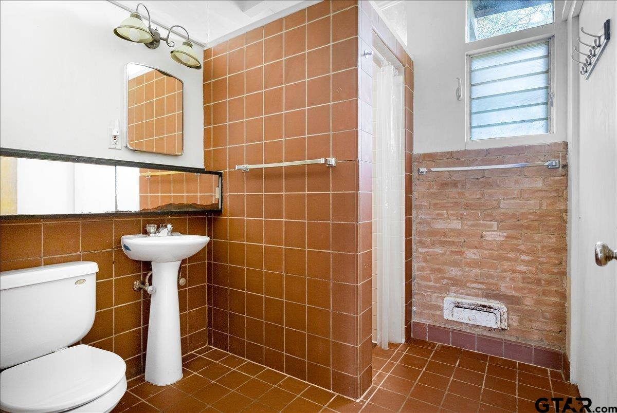 904 East Dulse Street Tyler, TX 75701 - Photo 21 of 27 a bathroom with a sink toilet and shower