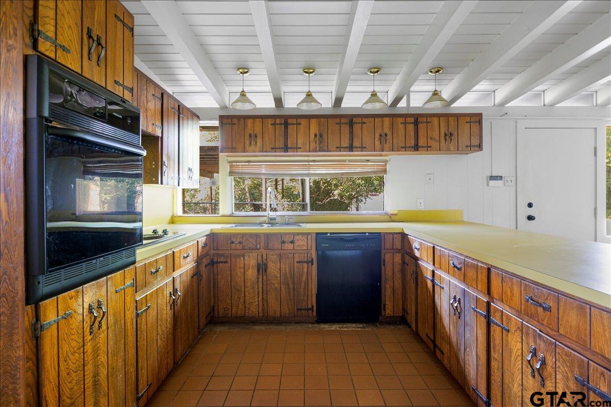 904 East Dulse Street Tyler, TX 75701 - Photo 7 of 27 a large kitchen with stainless steel appliances granite countertop a large stove a sink and dishwasher