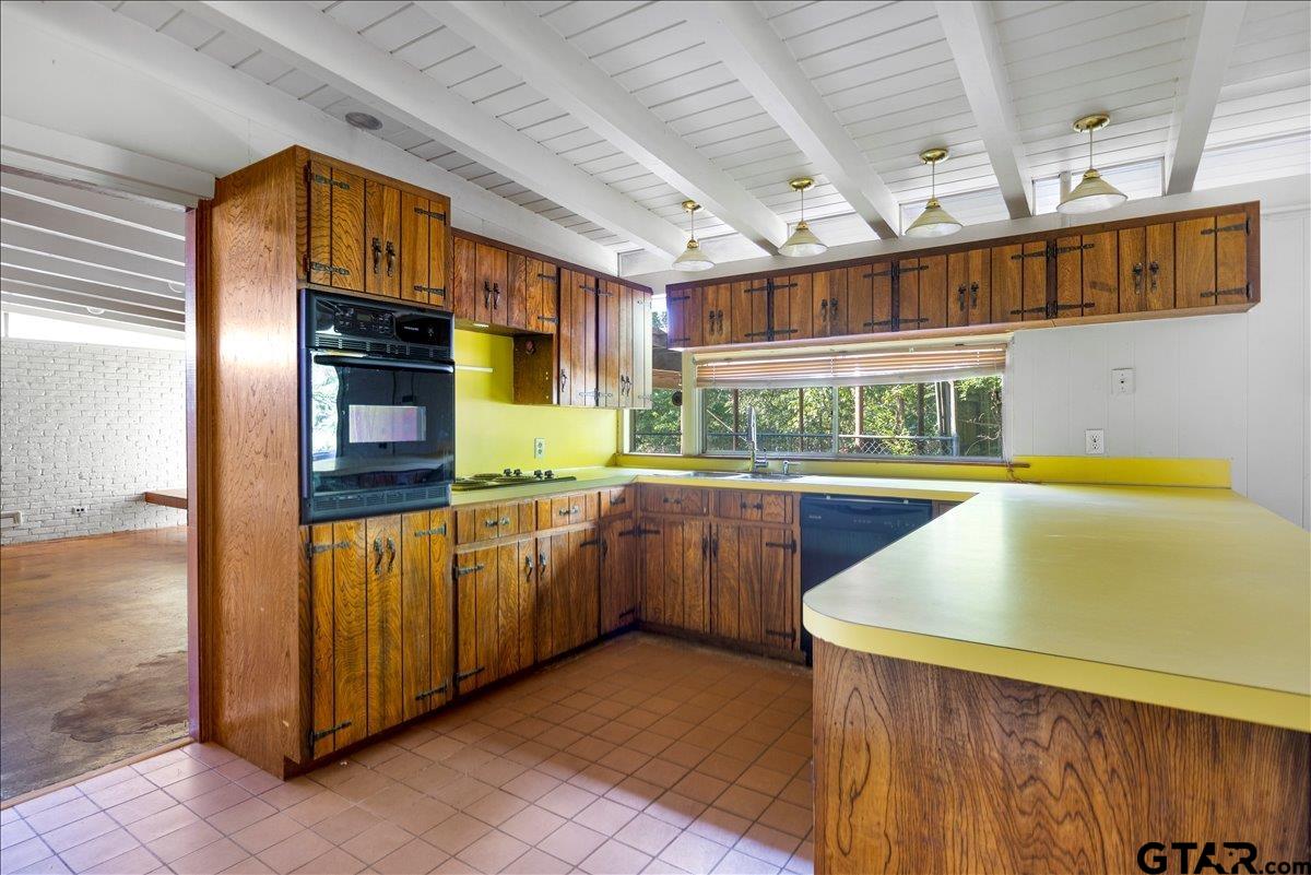 904 East Dulse Street Tyler, TX 75701 - Photo 8 of 27 a kitchen with stainless steel appliances granite countertop a sink and cabinets