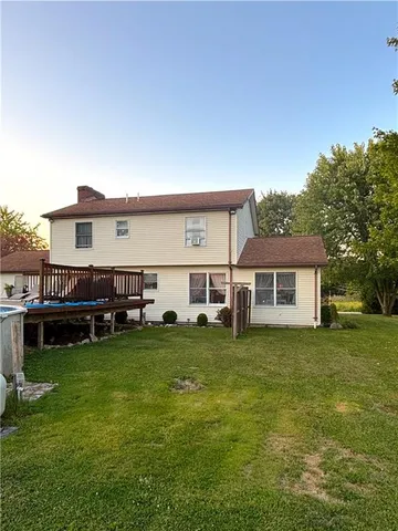 a view of a house with a yard and sitting area