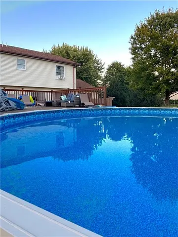 a view of a house with pool and sitting area