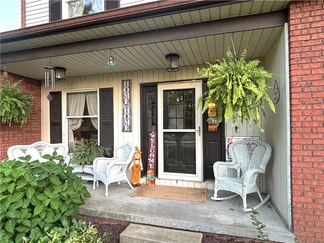 a living room filled with furniture and a potted plant