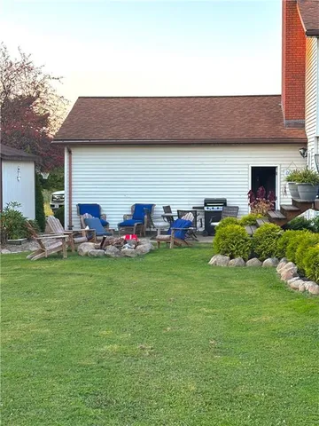 a backyard of a house with table and chairs