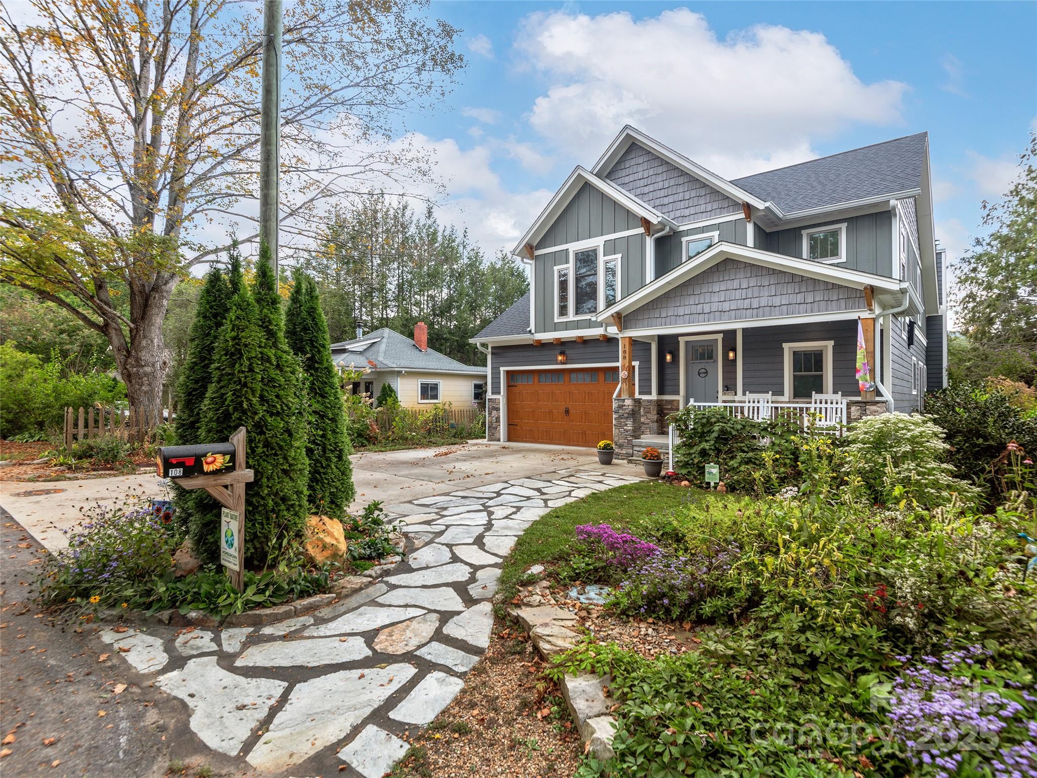 a front view of a house with a garden