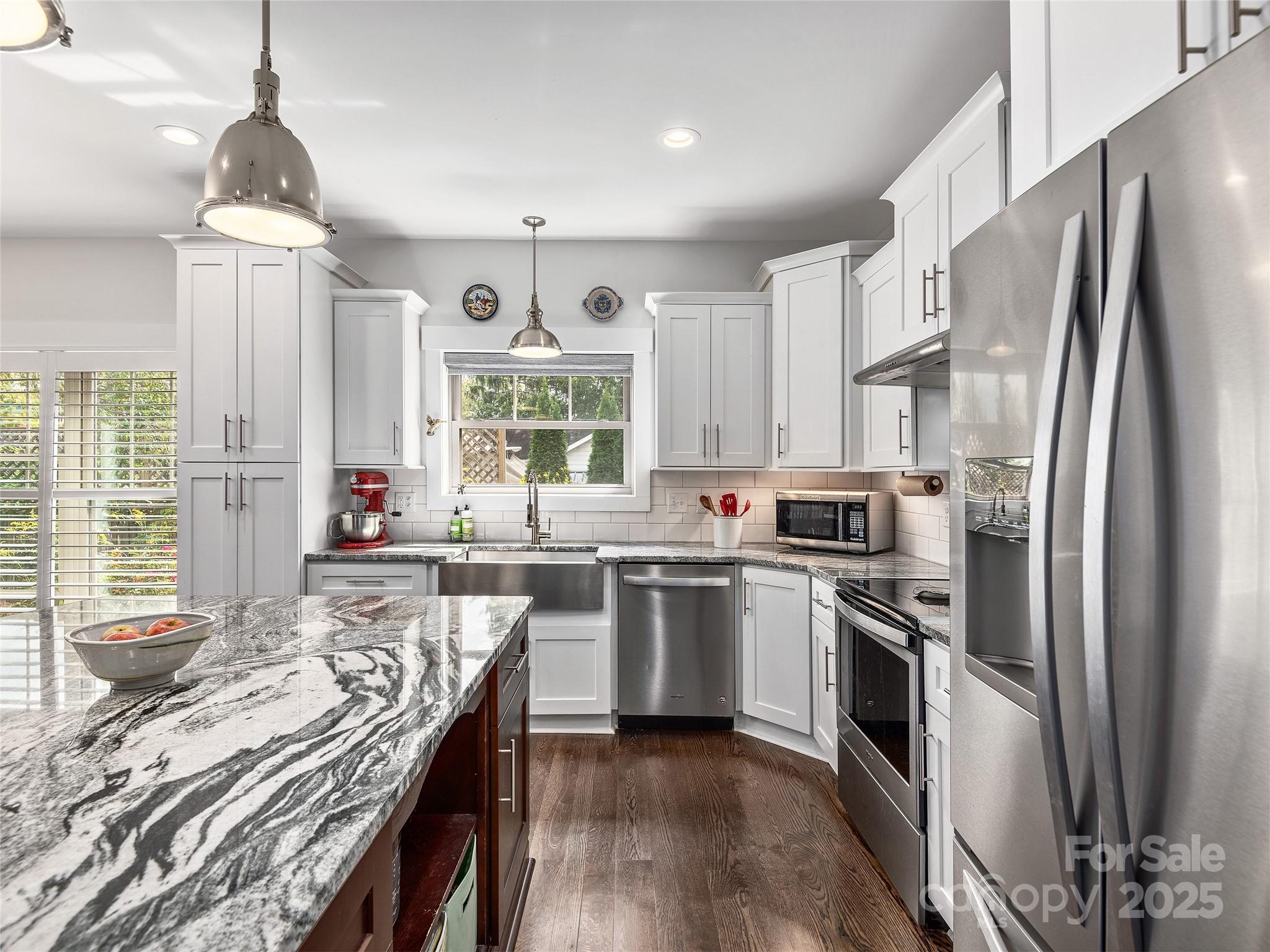108 Enthoffer Road Black Mountain, NC 28711 - Photo 9 of 31 a kitchen with stainless steel appliances granite countertop a stove a sink dishwasher a refrigerator white cabinets and wooden floor