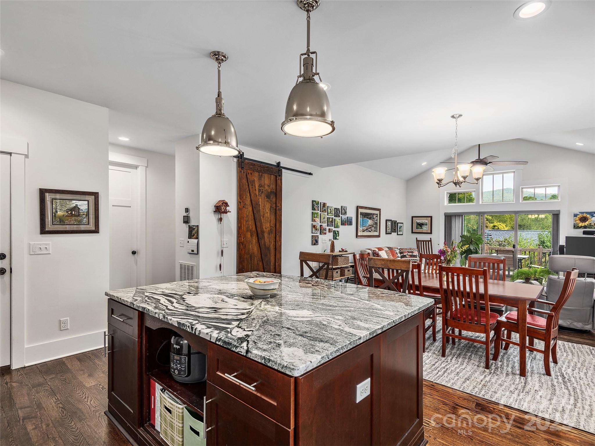 108 Enthoffer Road Black Mountain, NC 28711 - Photo 10 of 31 a kitchen with stainless steel appliances granite countertop wooden floors and white cabinets