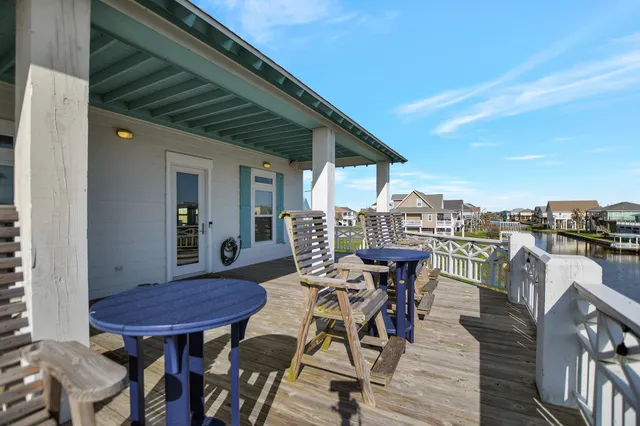 a view of a chairs and table in patio with a barbeque