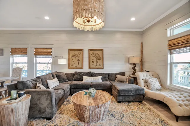 a living room with furniture wooden floor and a large window