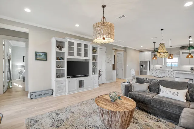 a living room with furniture a dining table and a flat screen tv
