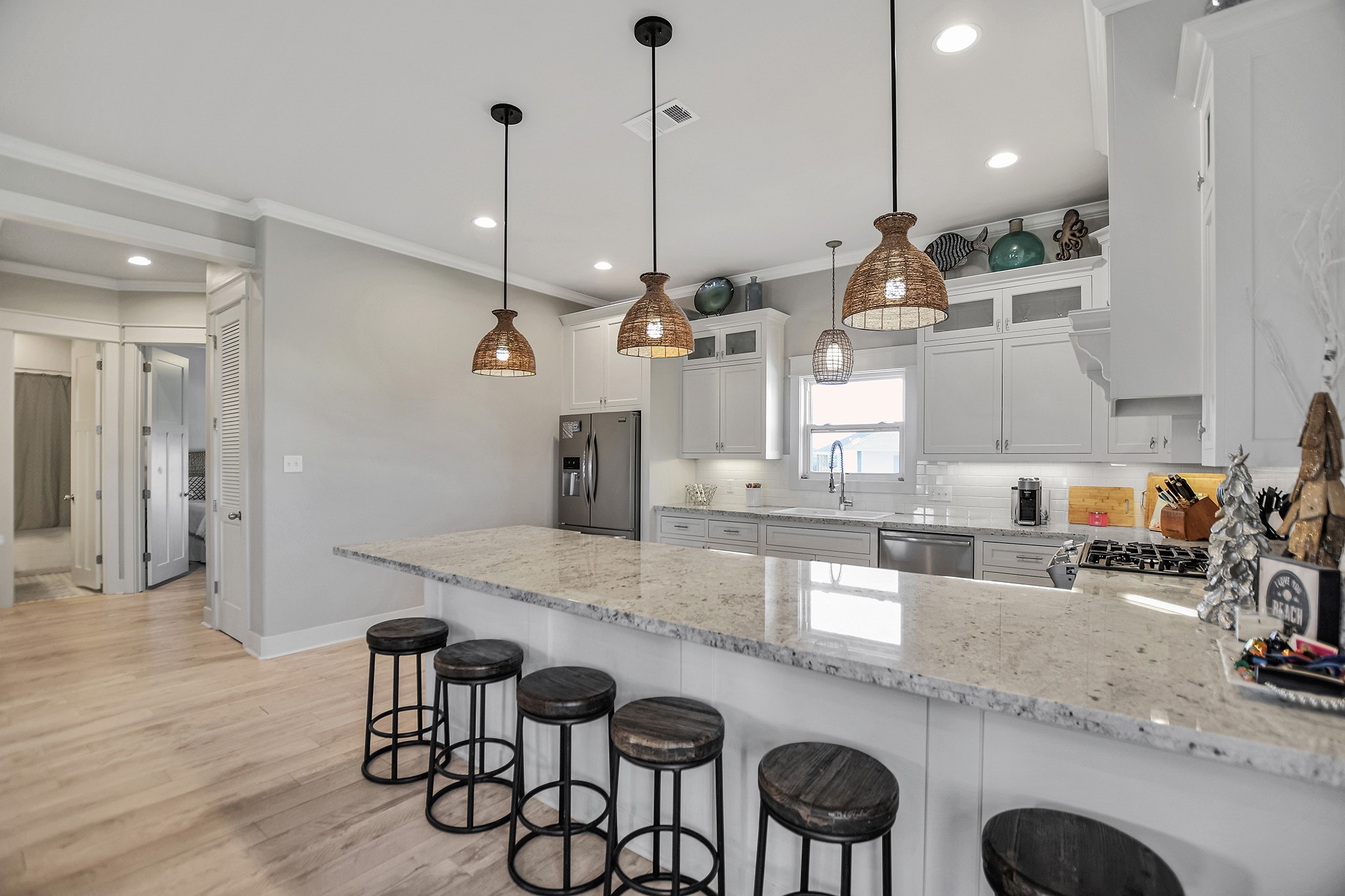 2570 Tide Road Port Bolivar, TX 77650 - Photo 23 of 50 a kitchen with granite countertop a sink a stove and chairs