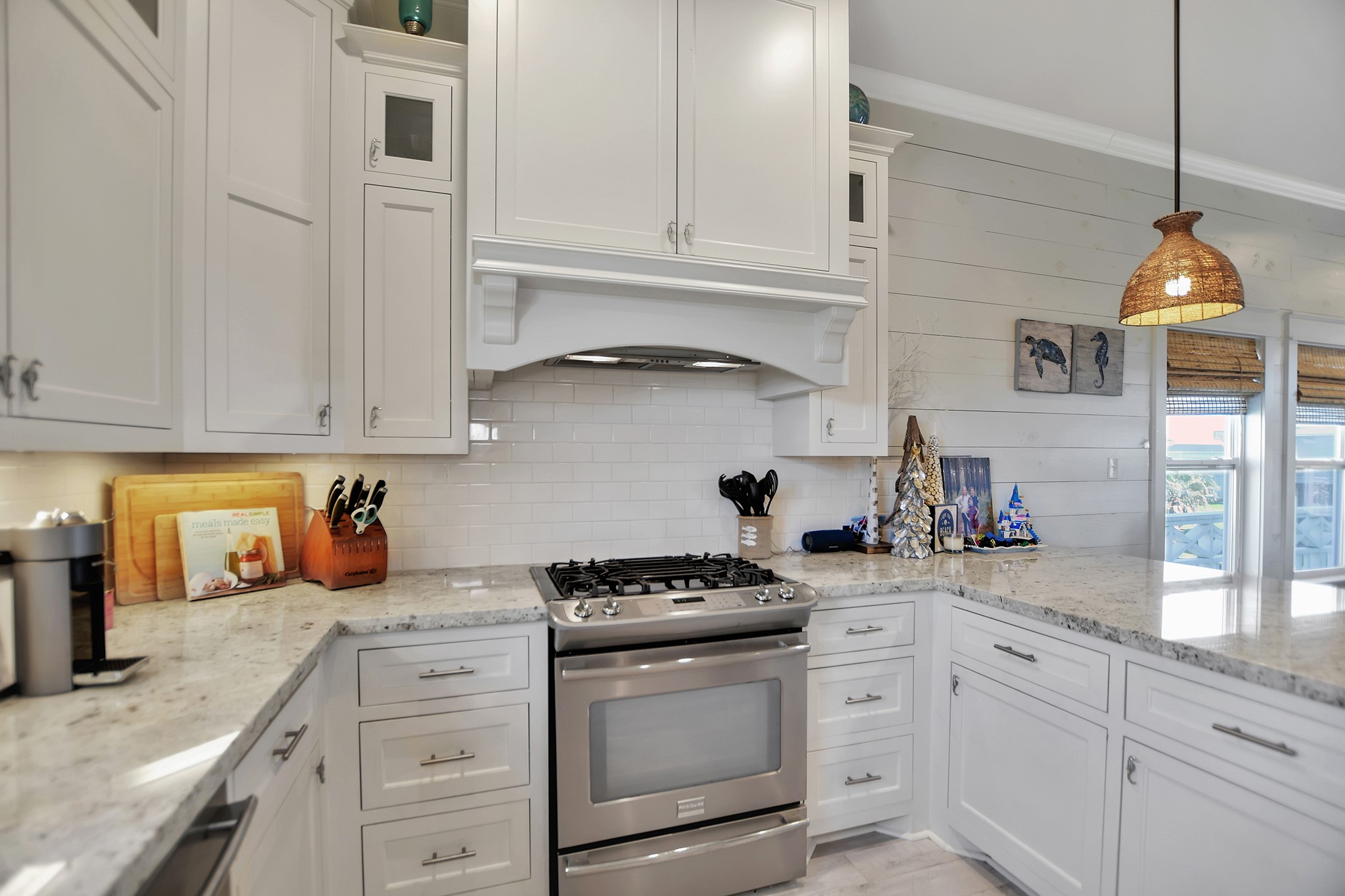 2570 Tide Road Port Bolivar, TX 77650 - Photo 27 of 50 a kitchen with white cabinets and appliances