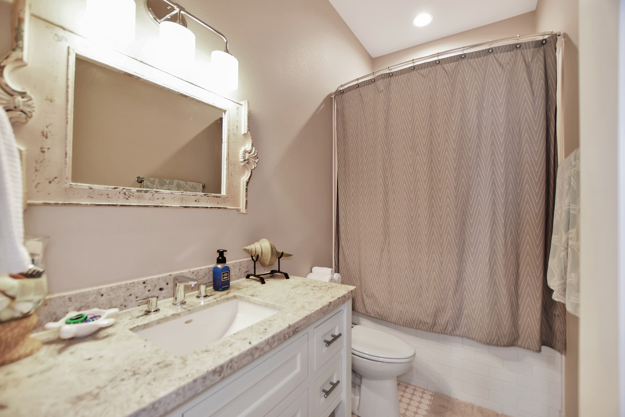 2570 Tide Road Port Bolivar, TX 77650 - Photo 37 of 50 a bathroom with a granite countertop sink and a mirror with toilet
