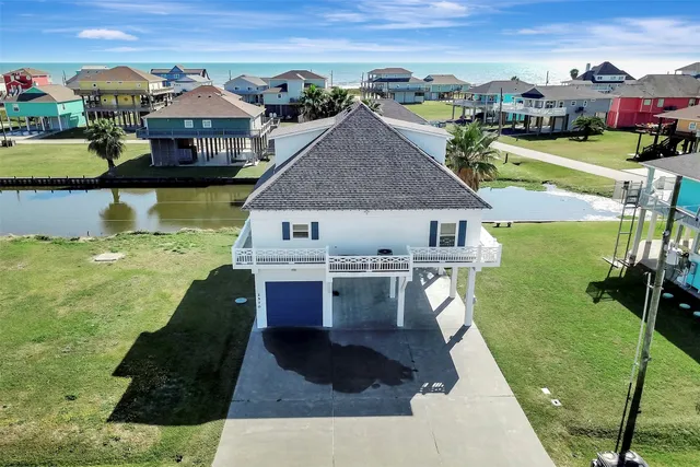 a aerial view of a house with a garden and lake view